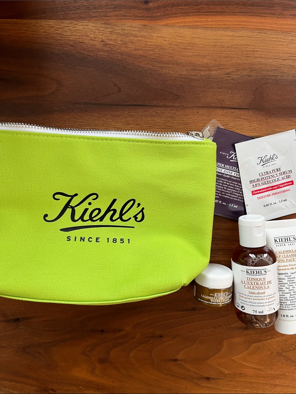 Kiehl's Bright Lime Green Travel Pouch with Calendula Toner, cleanser and cream